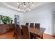 Elegant dining area featuring a wooden table, stylish chairs, and modern lighting at 534 Siltstone Pl, Cary, NC 27519