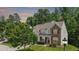 Stunning home with a well-manicured lawn, stone accents, and lush greenery, offering curb appeal at 534 Siltstone Pl, Cary, NC 27519