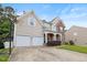 Attractive two-story home with a two-car garage, stone accents, and well-maintained landscaping at 534 Siltstone Pl, Cary, NC 27519