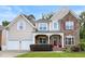 Charming two-story home with stone accents, a well-manicured lawn, and a two-car garage at 534 Siltstone Pl, Cary, NC 27519