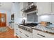 Beautiful kitchen featuring stainless steel appliances, granite countertops, and a modern range hood at 534 Siltstone Pl, Cary, NC 27519