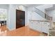 Kitchen featuring white cabinetry, hardwood floors, stainless appliances, and nearby staircase at 534 Siltstone Pl, Cary, NC 27519