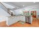 Open kitchen featuring white cabinets, granite countertops, and modern stainless steel appliances at 534 Siltstone Pl, Cary, NC 27519