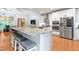 Modern kitchen with an oversized island, stainless steel appliances, and bright white cabinetry at 534 Siltstone Pl, Cary, NC 27519