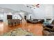 Open-concept living space showcasing kitchen island, staircase, and living room with comfortable seating and hardwood floors at 534 Siltstone Pl, Cary, NC 27519