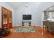 Spacious living room with vaulted ceilings, wood floors, and an entertainment center is ideal for relaxing or entertaining at 534 Siltstone Pl, Cary, NC 27519