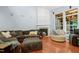 Relaxing living room with a charming fireplace, lots of soft seating and a large window showcasing the landscaped yard at 534 Siltstone Pl, Cary, NC 27519