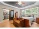 Main bedroom featuring trey ceiling, hardwood floors, ensuite bathroom, and large window with lots of natural light at 534 Siltstone Pl, Cary, NC 27519
