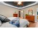 Spacious main bedroom boasts hardwood floors, a tray ceiling, and classic wooden furniture at 534 Siltstone Pl, Cary, NC 27519