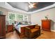 The main bedroom features hardwood floors, wooden furniture, and a tray ceiling with a ceiling fan at 534 Siltstone Pl, Cary, NC 27519