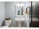Stylish powder room features pedestal sink, decorative mirror, and convenient toilet location near entry way at 534 Siltstone Pl, Cary, NC 27519
