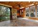 Inviting sunroom with stone fireplace, wood ceiling and floors, and large windows showcasing wooded landscape at 534 Siltstone Pl, Cary, NC 27519