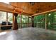 Cozy sunroom features slate floors, wood ceiling, and panoramic views of the private, wooded backyard at 534 Siltstone Pl, Cary, NC 27519