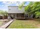 Large backyard with a covered porch, a wood pathway, and a spacious grassy area at 6001 Winged Willet Ct, Wendell, NC 27591