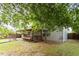 Cozy backyard featuring a covered porch with bench seating, and spacious lawn perfect for outdoor activities at 6001 Winged Willet Ct, Wendell, NC 27591