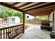 Covered patio offering outdoor seating and views of the fenced backyard and storage shed at 6001 Winged Willet Ct, Wendell, NC 27591