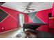 Vibrant bedroom features unique gray and red painted walls and a comfortable carpeted floor at 6001 Winged Willet Ct, Wendell, NC 27591