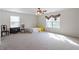 Spacious bedroom with carpet flooring, a ceiling fan, and two large windows at 6001 Winged Willet Ct, Wendell, NC 27591