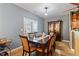 Dining room featuring an elegant dining table and a decorative china cabinet at 6001 Winged Willet Ct, Wendell, NC 27591