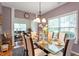 Bright dining room featuring a glass table, elegant chairs, and ample natural light from the window at 6001 Winged Willet Ct, Wendell, NC 27591