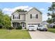 Charming two-story home boasts a well-manicured lawn, covered front porch, and paved driveway with ample parking at 6001 Winged Willet Ct, Wendell, NC 27591