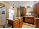 Functional kitchen featuring an island, dark countertops, and ample storage, conveniently located next to laundry at 6001 Winged Willet Ct, Wendell, NC 27591