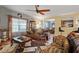 Inviting living room with a ceiling fan, stylish furnishings, and views into the dining and kitchen areas at 6001 Winged Willet Ct, Wendell, NC 27591