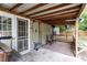 Relaxing covered back patio with wood flooring and seating area, perfect for entertaining at 6001 Winged Willet Ct, Wendell, NC 27591