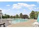 Spacious community pool with lounge chairs, greenery, and clear blue skies providing a relaxing atmosphere at 6001 Winged Willet Ct, Wendell, NC 27591