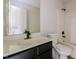 Well-lit bathroom featuring a modern vanity and a combined shower and bathtub at 616 Cheselden Dr, Durham, NC 27713