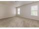 Spacious bedroom with plush carpeting and bright natural light from two windows at 616 Cheselden Dr, Durham, NC 27713