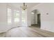 Bright dining area features large windows, modern flooring, and stylish light fixture at 616 Cheselden Dr, Durham, NC 27713