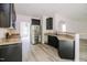 Modern kitchen with stainless steel appliances, granite countertops, and sleek black cabinetry at 616 Cheselden Dr, Durham, NC 27713