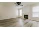 Spacious living room features a decorative fireplace, large windows, and modern ceiling fan at 616 Cheselden Dr, Durham, NC 27713