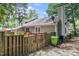 Charming backyard showcasing the home's exterior, wooden fence, and lush green surroundings at 6213 Fountainhead Dr, Raleigh, NC 27609