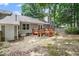 Exterior backyard view featuring a wood deck, neutral siding, and a well-maintained lawn at 6213 Fountainhead Dr, Raleigh, NC 27609