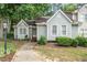 Charming home with light blue siding, a well-manicured lawn, and a welcoming walkway to the front door at 6213 Fountainhead Dr, Raleigh, NC 27609