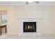 Living room fireplace has brick surround and dark accent trim at 6213 Fountainhead Dr, Raleigh, NC 27609