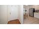 Bright entryway leading to the kitchen featuring modern appliances, tile flooring, and a dining nook at 6213 Fountainhead Dr, Raleigh, NC 27609