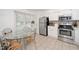 Well-lit kitchen features stainless steel appliances, tile backsplash, and an adjacent dining area with a glass table at 6213 Fountainhead Dr, Raleigh, NC 27609