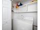 Functional laundry room with washer, dryer, and built-in shelving for storage at 6213 Fountainhead Dr, Raleigh, NC 27609