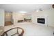 Open living room features brick fireplace, ceiling fan and wood flooring near entry at 6213 Fountainhead Dr, Raleigh, NC 27609
