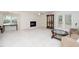 Spacious living room featuring a fireplace, white carpeting, a ceiling fan, and sliding glass doors at 6213 Fountainhead Dr, Raleigh, NC 27609