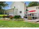 Landscaped backyard with a deck, patio, and well-maintained garden at 633 Fleming Rd, Youngsville, NC 27596