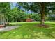 Scenic view of red barn, surrounded by green lawn and mature trees at 633 Fleming Rd, Youngsville, NC 27596
