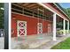 Exterior of red barn with white trim, open doorway, and swing at 633 Fleming Rd, Youngsville, NC 27596