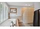 Bathroom with a garden tub, glass block shower, and shuttered window at 633 Fleming Rd, Youngsville, NC 27596