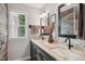 Modern bathroom with dual sinks, granite countertops, and rustic wood accent wall at 633 Fleming Rd, Youngsville, NC 27596