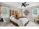 Bright bedroom with wooden headboard, neutral colors, and a ceiling fan at 633 Fleming Rd, Youngsville, NC 27596