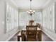 Charming dining room with plantation shutters, a chandelier, and rustic wooden table, perfect for Gathering meals at 633 Fleming Rd, Youngsville, NC 27596